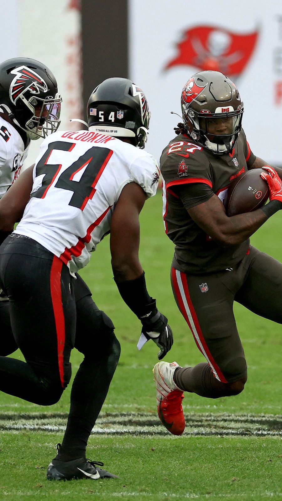 Mike Davis of the Atlanta Falcons is tackled by Antoine Winfield