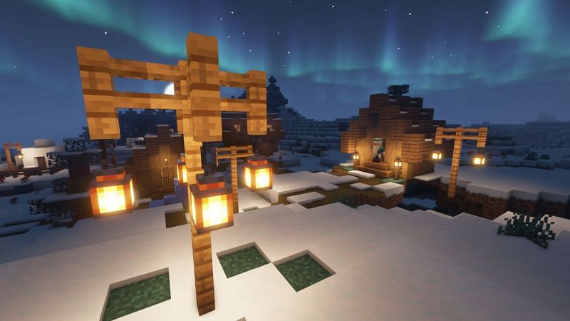 Lanterns in a snowy tundra village (Image via Minecraft)