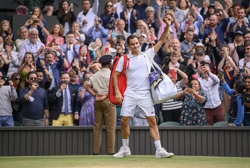 Roger Federer waves to fans following his exit at Wimbledon 2021