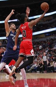 Maxi Kleber constests Coby White's layup attempt