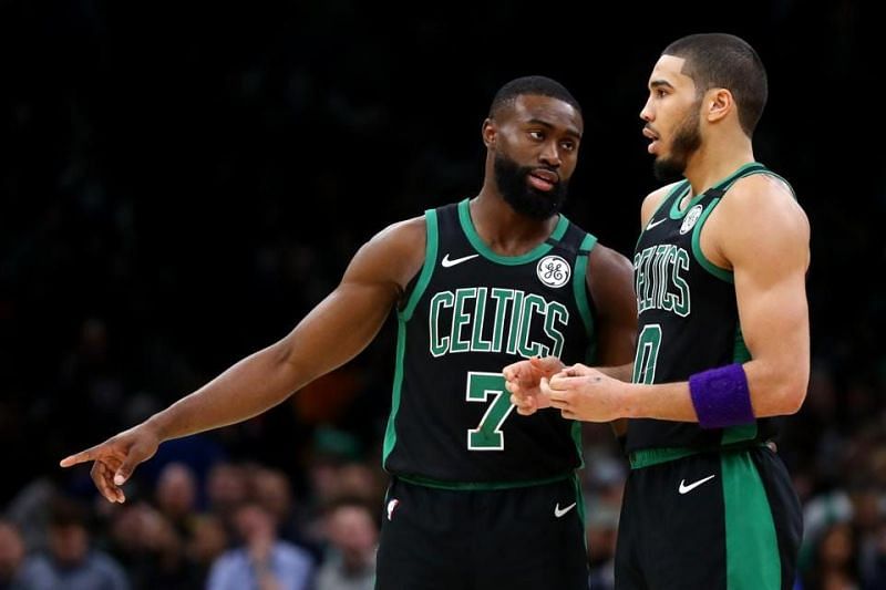 Jayson Tatum talks to Jaylen Brown during a lull in an NBA game.