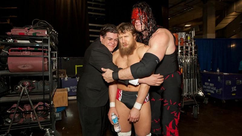 Kane hugs it out with his Team Hell No partner Daniel Bryan and Ricardo Rodriguez