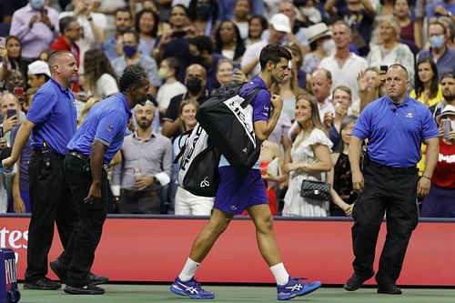 Novak Djokovic walks off court after beating Holger Rune