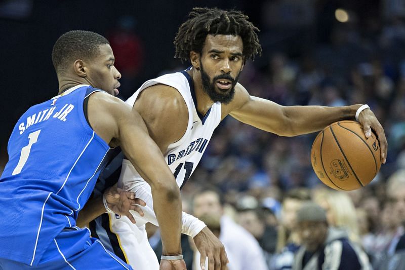 Mike Conley #11 of the Memphis Grizzlies with the ball and being guarded by Dennis Smith Jr. #1 of the Dallas Mavericks at the FedEx Forum on October 26, 2017 in Memphis, Tennessee.