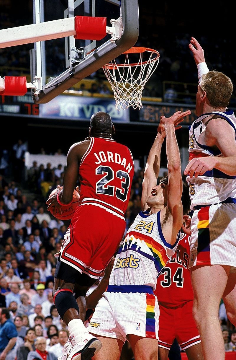 Michael Jordan (#23) of the Chicago Bulls jumps with the ball during the game against the Denver Nuggets.