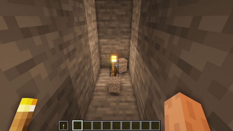 Gravel blocks break when fallen on a torch (Image via Minecraft)