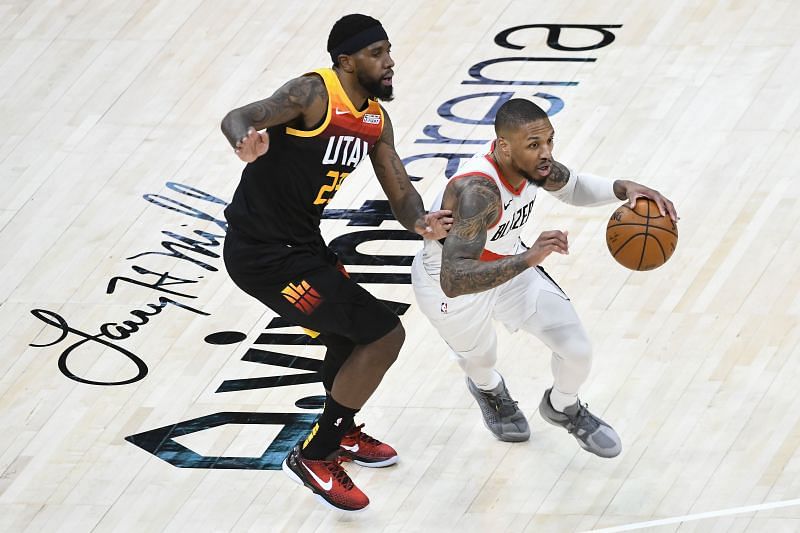 Damian Lillard (#0) of the Portland Trail Blazers drives past Royce O&#039;Neale (#23) of the Utah Jazz.