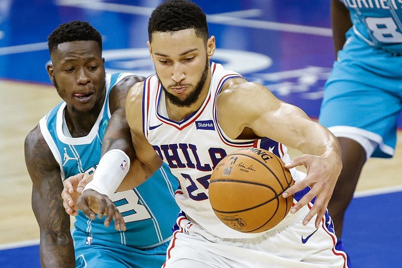 Ben Simmons fights to keep possession against Terry Rozier during an NBA game.