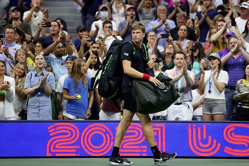 Jenson Brooksby walks off court after losing to Novak Djokovic