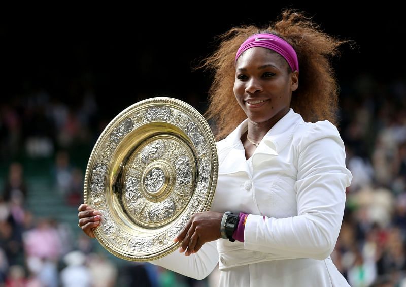 Serena Williams poses with the 2012 Wimbledon trophy