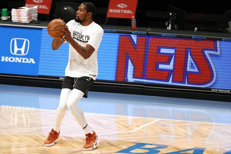 Kevin Durant warms up ahead of a game