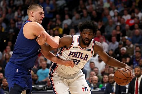 Nikola Jokic (#15) of the Denver Nuggets guards Joel Embiid (#21) of the Philadelphia 76ers.