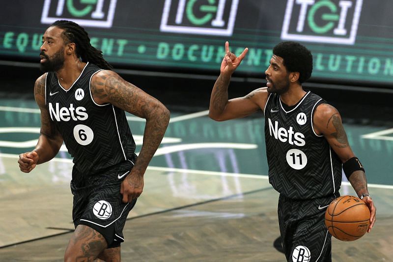 DeAndre Jordan and Kyrie Irving in action during an NBA game.