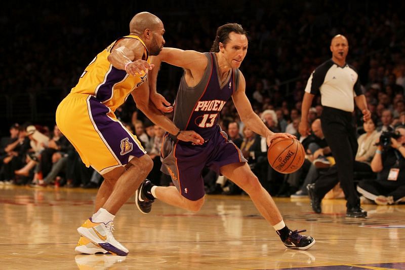 Steve Nash #13 of the Phoenix Suns drives with the ball on Derek Fisher #2