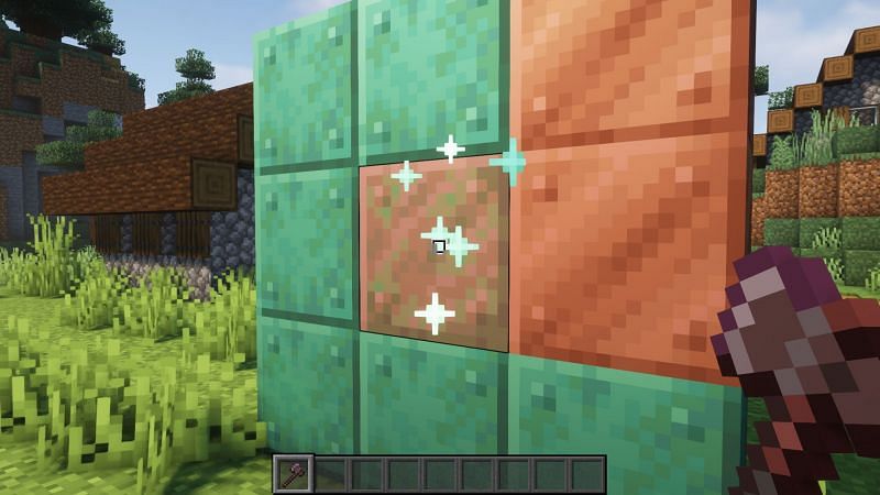 Deoxidizing copper block using an axe (Image via Minecraft)