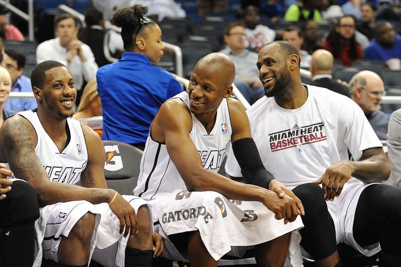 Mario Chalmers (extreme left) and LeBron James (extreme right) share a light moment during an NBA game.