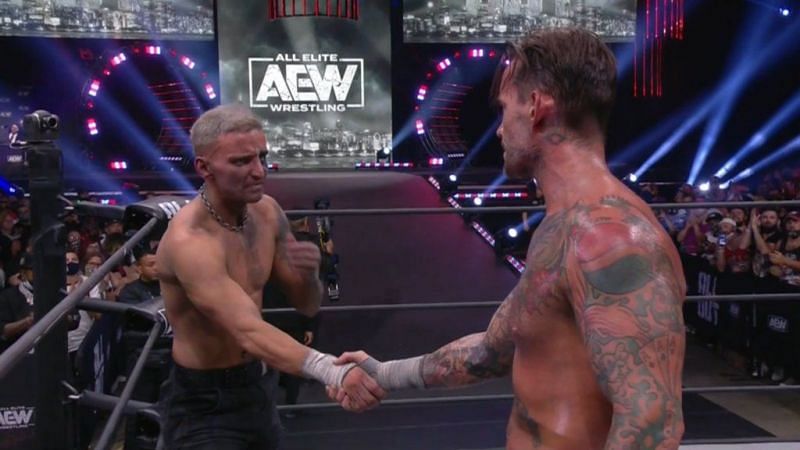 CM Punk and Darby Allin shake hands after their match.