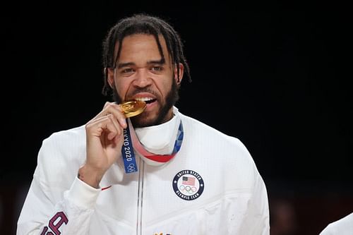 JaVale McGee bites into his Olympic gold medal