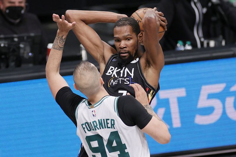 Kevin Durant #7 of the Brooklyn Nets looks to pass as Evan Fournier #94 of the Boston Celtics defends