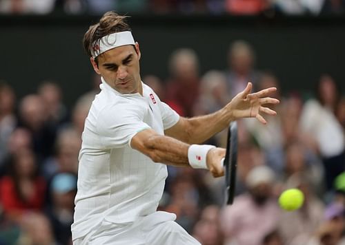 Roger Federer strikes a forehand at Wimbledon 2021