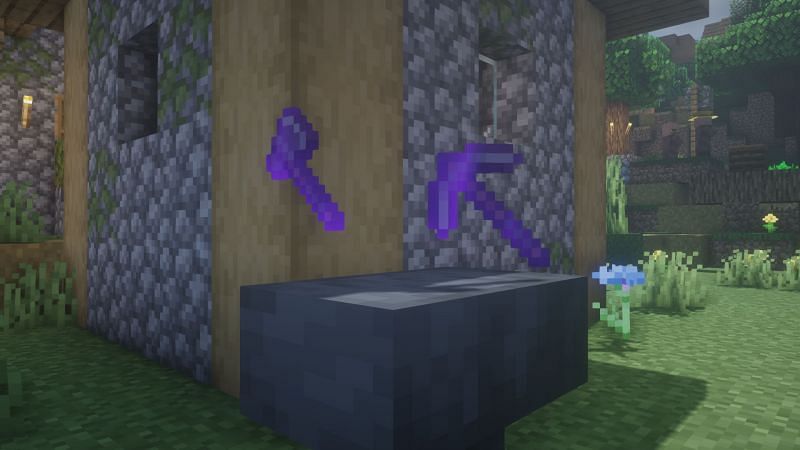 Enchanted pickaxe and axe on an anvil (Image via Minecraft)