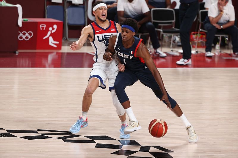 Frank Ntilikina (right) drives past Devin Booker during a game between the United States and France.
