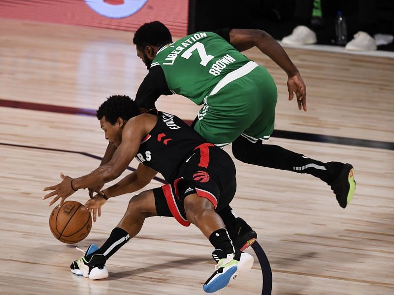 Jaylen Brown attempts to steal the ball away from Kyle Lowry of the Toronto Raptors.