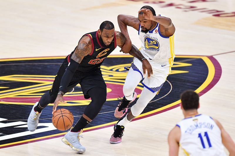 LeBron James #23 of the Cleveland Cavaliers drives against Kevin Durant #35 of the Golden State Warriors