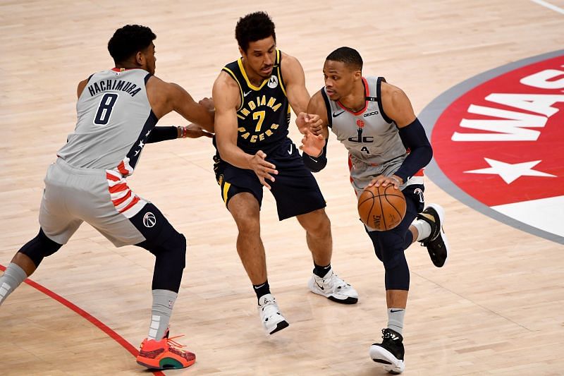 Russell Westbrook #4 of the Washington Wizards dribbles in front of Malcolm Brogdon #7 of the Indiana Pacers