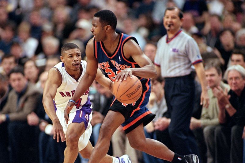 Charlie Ward #21 of the New York Knicks moves with the ball around Muggsy Bogues #14 of the Toronto Raptors during the NBA Eastern Conference Round One Game at the Air Canada Centre in Toronto, Ontario, Canada. The Knicks defeated the Raptors 87-80.