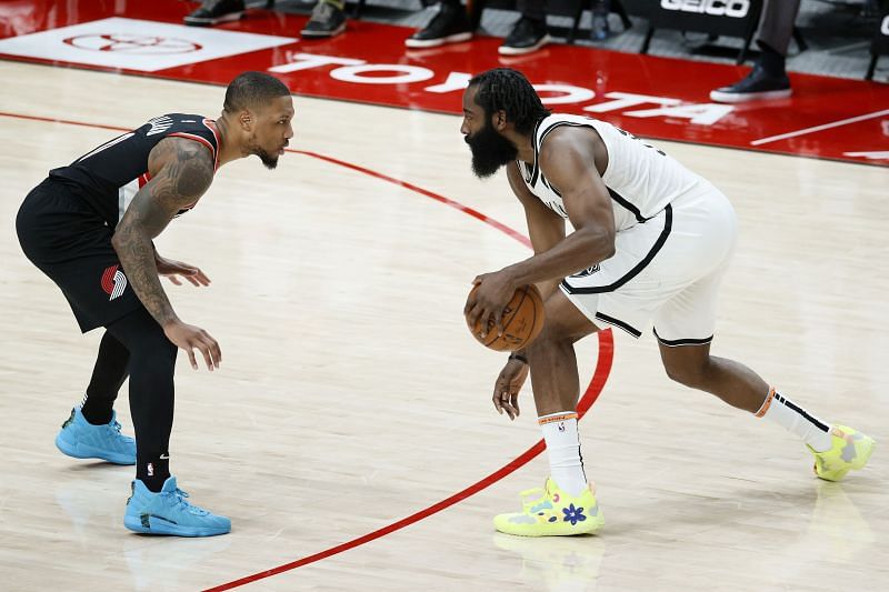 Damian Lillard (#0) defends against James Harden (#13) of the Brooklyn Nets.