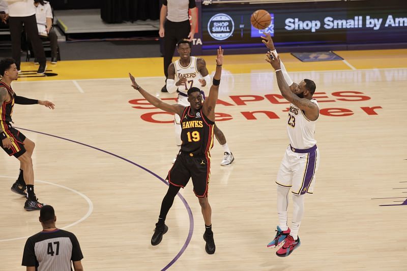 LeBron James (#23) attempts a three-pointer against Tony Snell #19.