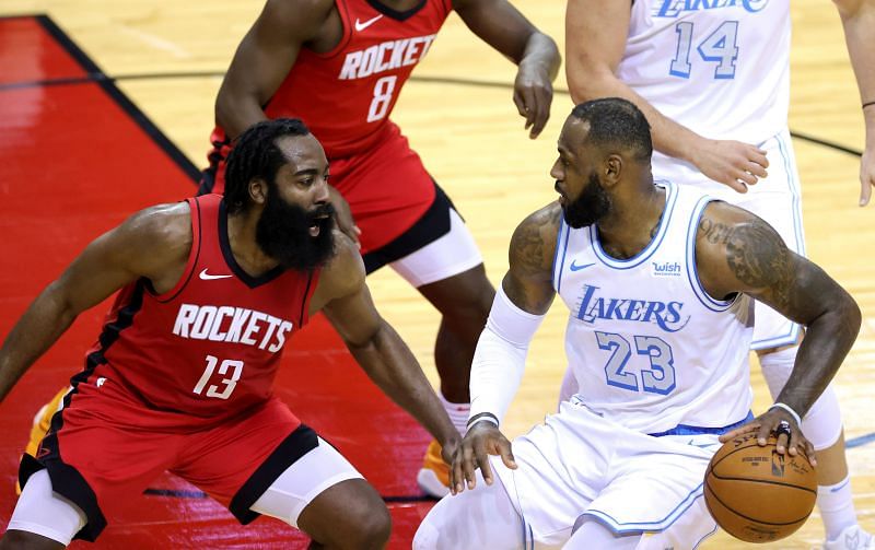 LeBron James #23 of the Los Angeles Lakers controls the ball ahead of James Harden #13 of the Houston Rockets during the second quarter of a game at Toyota Center on January 10, 2021 in Houston, Texas.