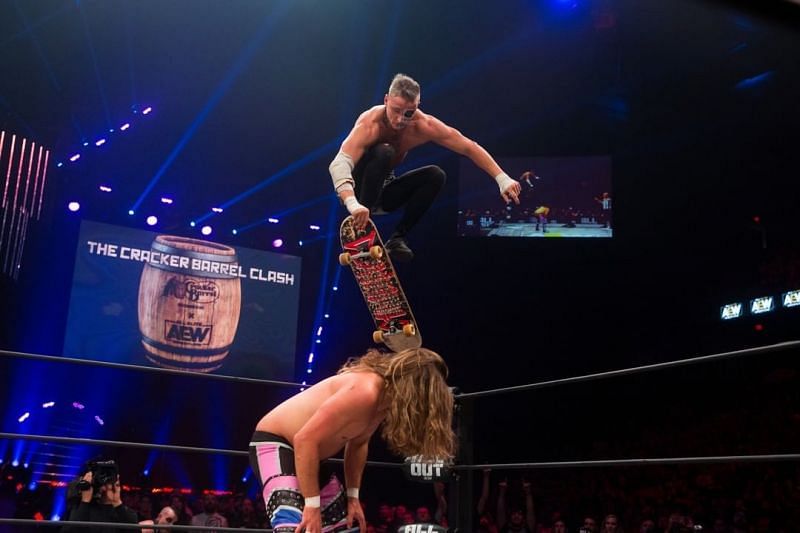 Darby Allin using his skateboard as a weapon