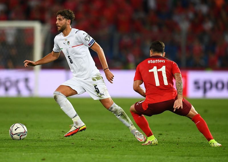 Italy&#039;s Manuel Locatelli (left) in action during his side&#039;s 2022 FIFA World Cup Qualifier against Switzerland