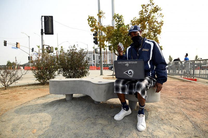 A fan on his laptop at a Dallas Cowboys v Los Angeles Rams game