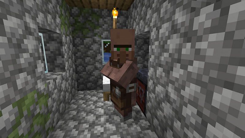 A Minecraft toolsmith villager standing in a cobblestone house (Image via Minecraft)