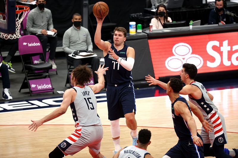 Luka Doncic #77) of the Dallas Mavericks puts up a shot over Robin Lopez (#15) of the Washington Wizards.