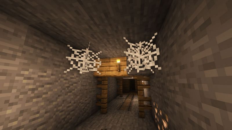 Cobwebs in a mineshaft (Image via Minecraft)