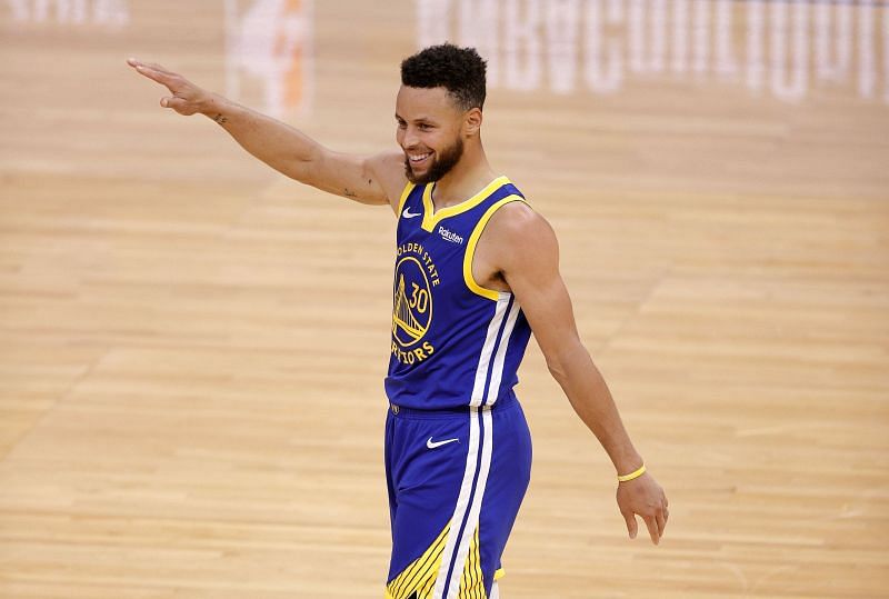 Stephen Curry is all smiles after scoring a basket