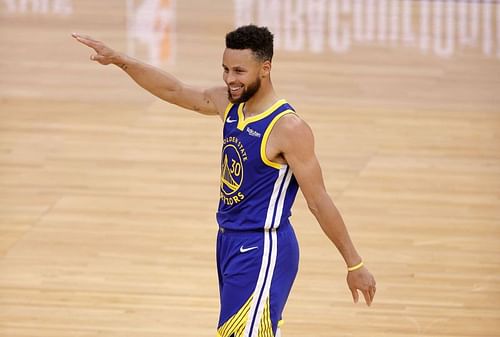 Stephen Curry is all smiles after scoring a basket