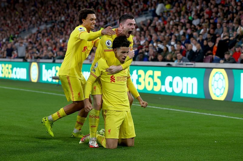 Curtis Jones (middle) celebrates with Trent Alexander-Arnold (left) and Andy Robertson (right).