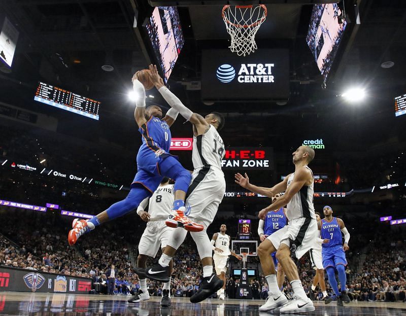 Russell Westbrook #0 of the Oklahoma City Thunder drives for two against Danny Green $14 of the San Antonio Spurs