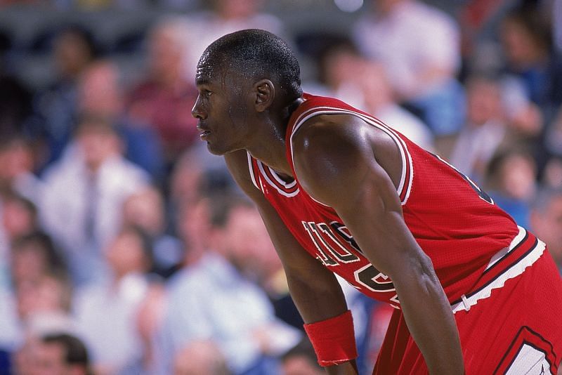 Michael Jordan rests on the court during a game
