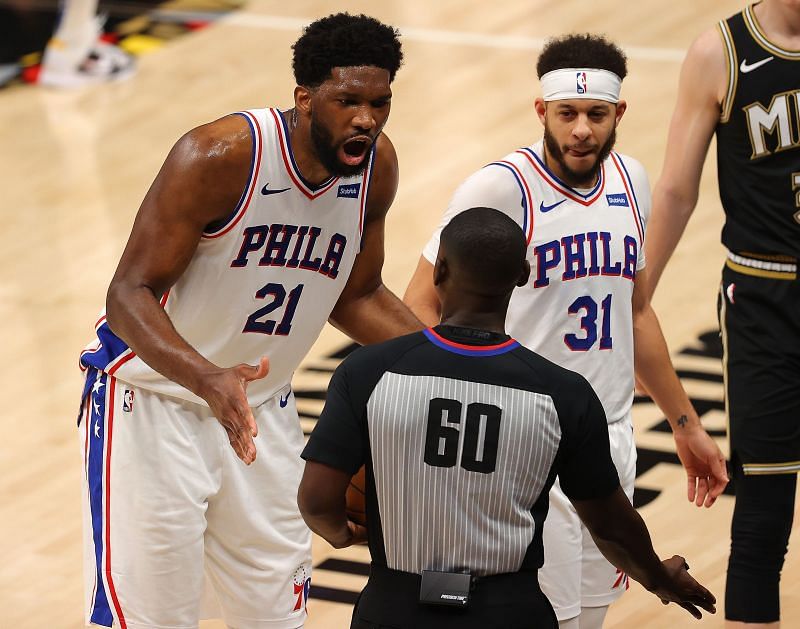 Joel Embiid #21 of the Philadelphia 76ers reacts referee James Williams #60 after being charged with an offensive foul against Clint Capela #15 of the Atlanta Hawks during the first half of game 6 of the Eastern Conference Semifinals at State Farm Arena on June 18, 2021 in Atlanta, Georgia.
