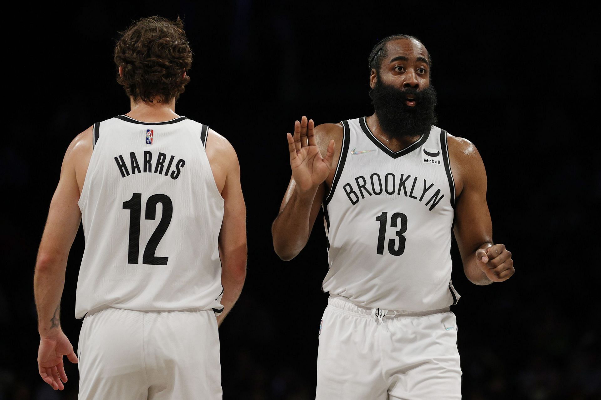 James Harden (#13) high-fives Joe Harris (#12) of the Brooklyn Nets