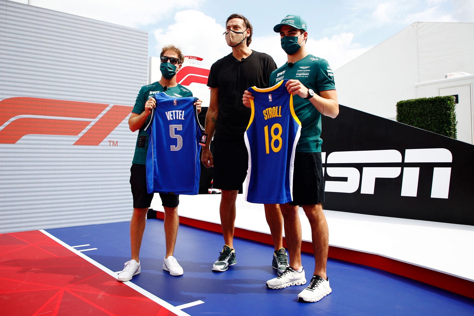 Sebastian Vettel and Lance Stroll of Aston Martin F1 Team pose for a photo with NBA legend Fabricio Oberto ahead of the F1 NBA free throw challenge. (Photo by Jared C. Tilton/Getty Images)