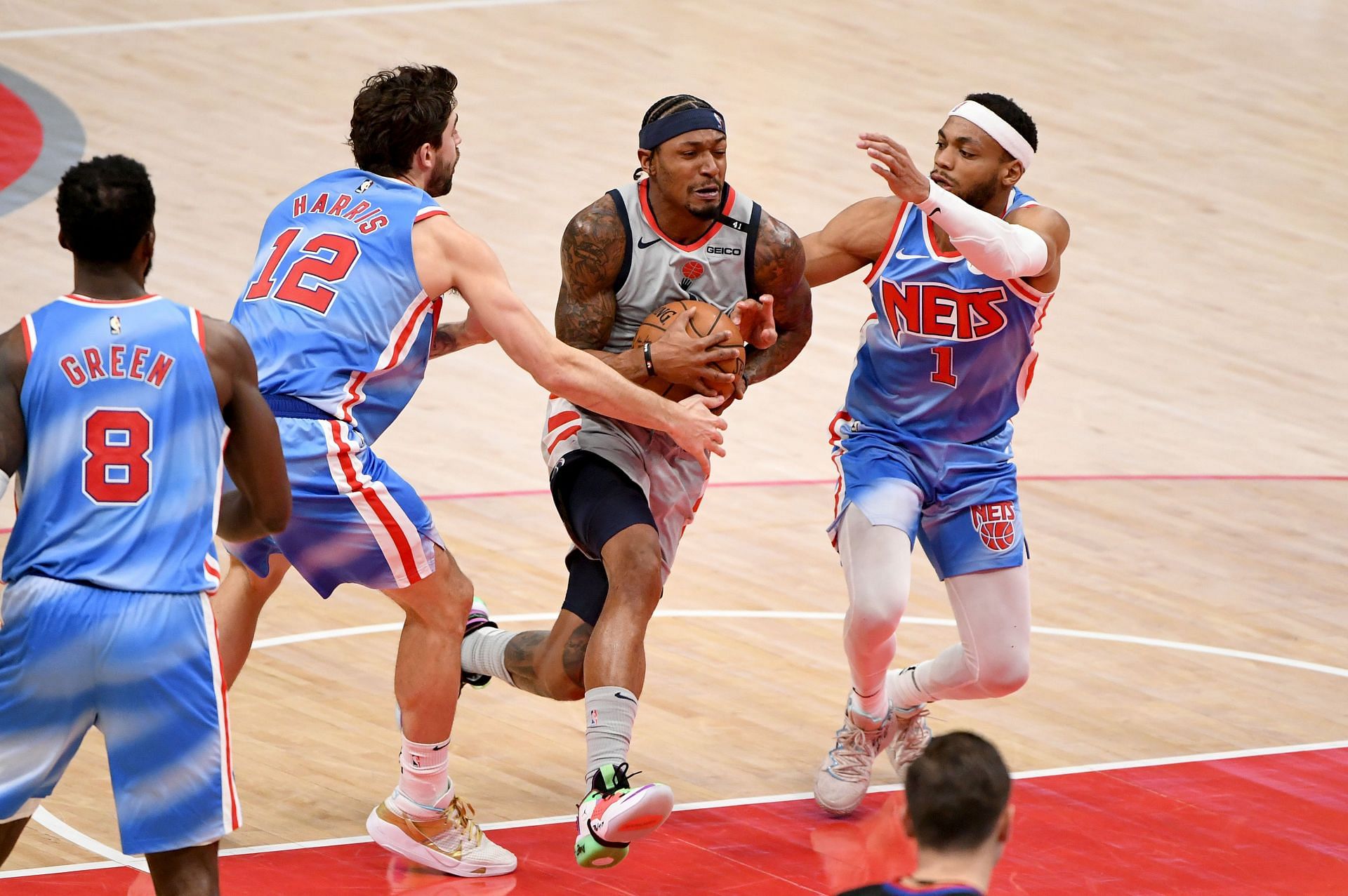 Bradley Beal #3 of the Washington Wizards dribbles against Joe Harris #12 and Bruce Brown #1 of the Brooklyn Nets