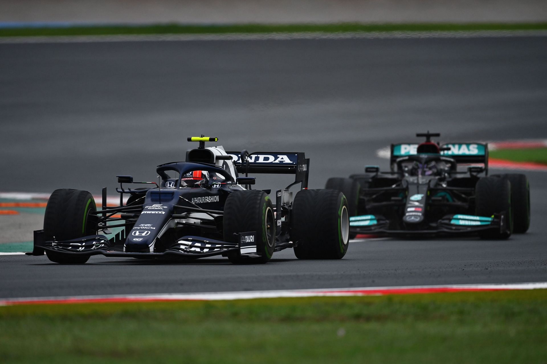 Pierre Gasly of Scuderia AlphaTauri leads Lewis Hamilton during the 2021 Turkish GP. (Photo by Dan Mullan/Getty Images)