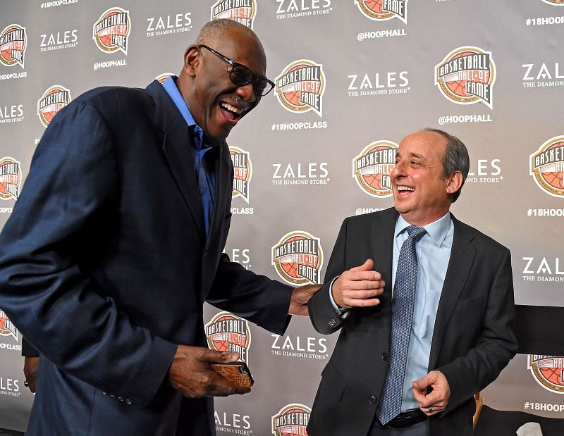 NBA photographer Andy Bernstein (R) shares a laugh with Bob McAdoo